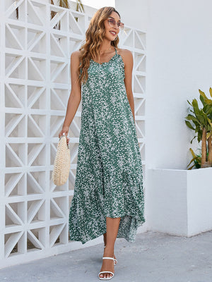 Model wearing a green Ditsy Floral Scoop Neck Midi Cami Dress, styled with a handbag and sandals against a modern backdrop.