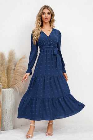 Navy Swiss Dot Tied Surplice Flounce Sleeve Dress paired with elegant accessories, perfect for any occasion.