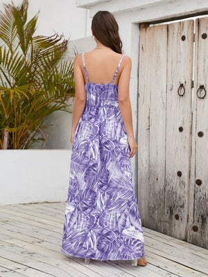 Back view of a printed surplice spaghetti strap dress with a tropical floral pattern, perfect for summer outings.