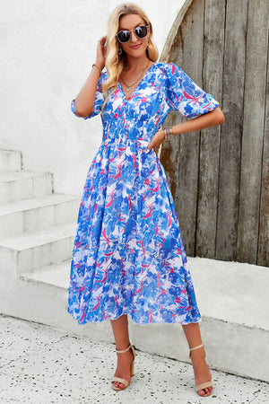 Smocked printed V-neck short sleeve dress in blue floral design, perfect for summer outings.