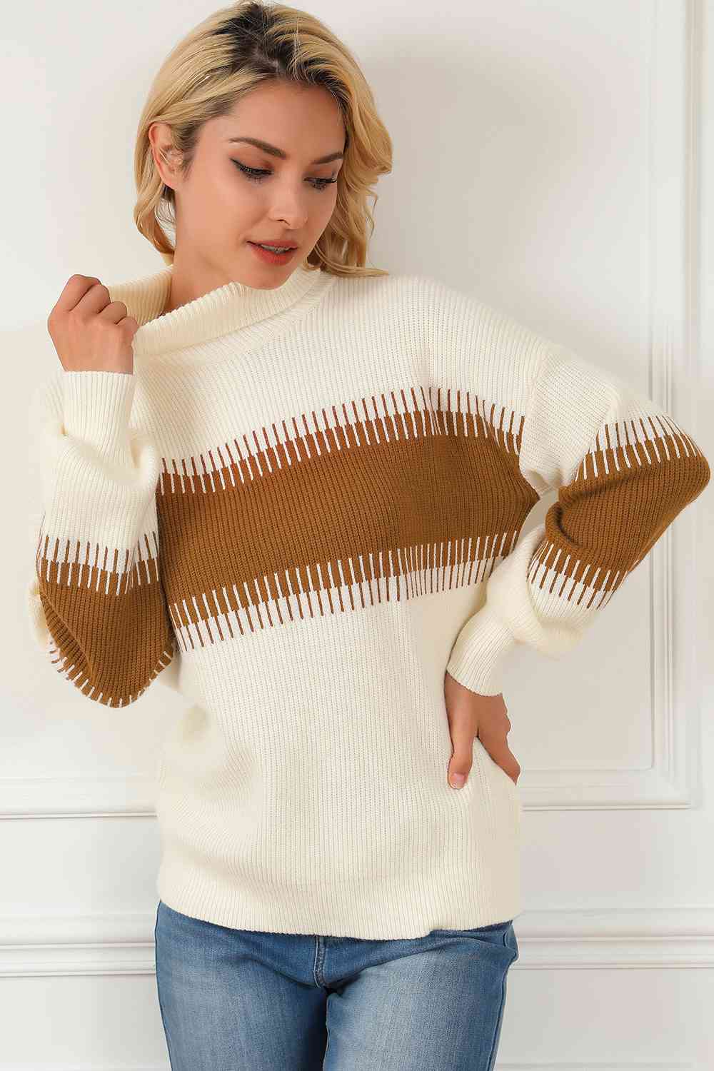 Model wearing a stylish contrast turtleneck long sleeve sweater, featuring a cream and brown striped design.