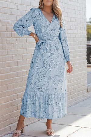 Light blue printed tie front ruffle hem dress featuring long sleeves and a flattering silhouette.