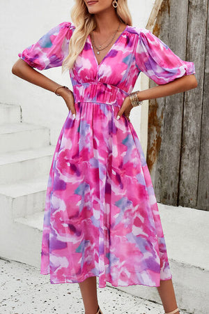 Smocked printed V-neck short sleeve dress in pink and purple hues, perfect for summer outings.