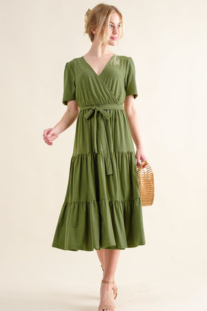 Stylish woman in a soft short sleeve tiered midi dress, perfect for casual outings or garden parties.