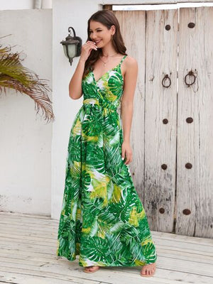 Model wearing a vibrant green printed surplice spaghetti strap dress with a floral design, standing outdoors.