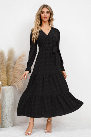 Elegant Swiss Dot Tied Surplice Flounce Sleeve Dress in black, featuring a flowing skirt and detailed texture.