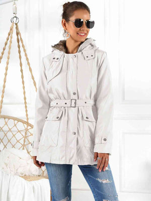 Stylish full size hooded jacket with detachable liner, modeled by a woman, featuring a belted waist and pockets.