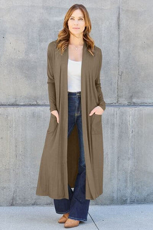 Model wearing Basic Bae Full Size Open Front Long Sleeve Cover Up in olive green with pockets, styled over a tank top and jeans.