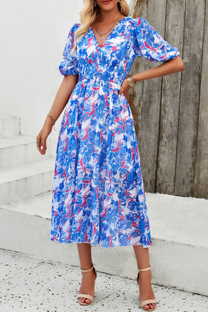 Smocked printed V-neck short sleeve dress in vibrant blue and pink floral pattern, perfect for summer occasions.