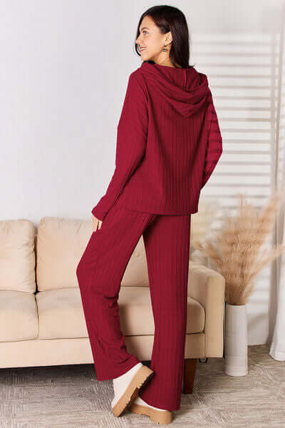 Model wearing a cozy red ribbed hoodie and pants set, perfect for chic loungewear.