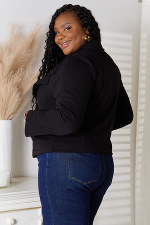 Back view of a woman in a black Culture Code zip-up jacket, showcasing style and versatility with jeans.