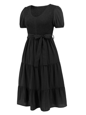 Black smocked tie front short sleeve tiered dress, perfect for casual outings or special occasions.