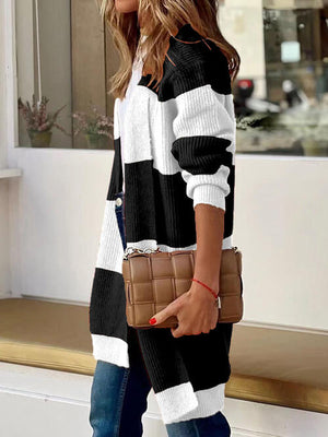 Contrast open front long sleeve cardigan in black and white, styled with a brown clutch, perfect for casual outfits.