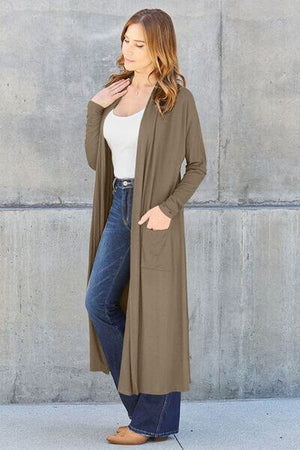 Woman wearing Basic Bae open front long sleeve cover up with pockets, paired with jeans for a stylish look.