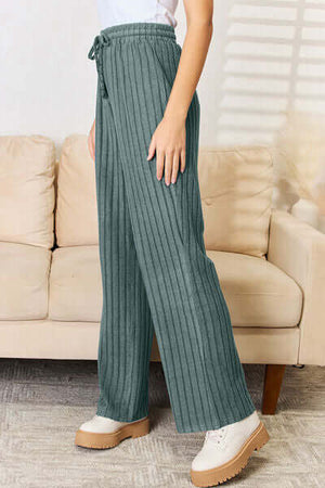 Cozy ribbed pants set in teal, featuring a drawstring waist for a comfortable fit and styled with platform shoes.