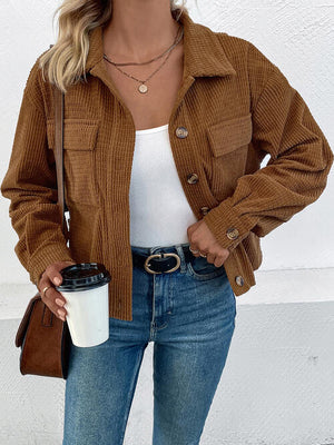 Collared neck button front jacket in brown corduroy with pockets, styled with a white top and jeans.