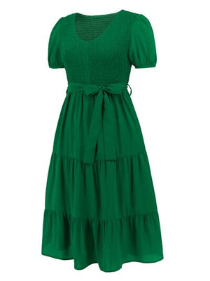 Smocked tie front short sleeve tiered dress in vibrant green, perfect for summer outings and casual events.