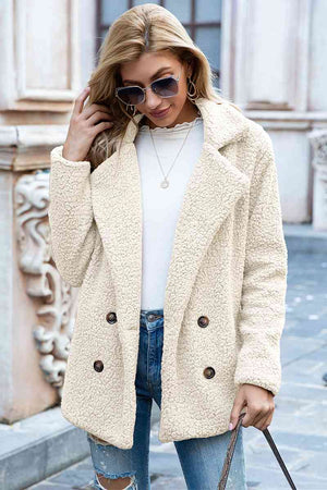 Model wearing a full size lapel collar sherpa coat with a double-breasted design, styled casually.