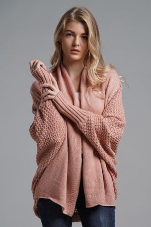 Model wearing a pink dolman sleeve open front ribbed longline cardigan, showcasing a casual and chic style.