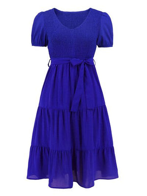 Smocked tie front short sleeve tiered dress in vibrant blue, featuring a flattering fit and layered design.