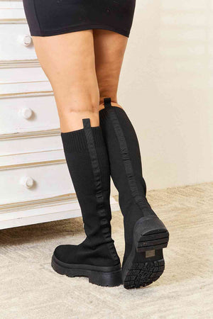 WILD DIVA Knee High Platform Sock Boots in black, showcasing a snug fit and stylish platform sole, perfect for elevating any outfit.