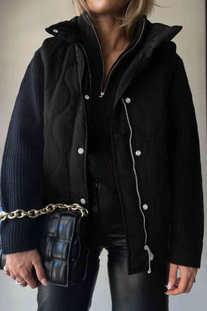 Stylish woman wearing a black quilted vest with pockets, paired with a chic handbag and black pants.