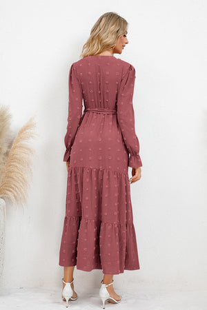 Back view of Swiss Dot Tied Surplice Flounce Sleeve Dress in rose color, featuring a tiered skirt and long sleeves.