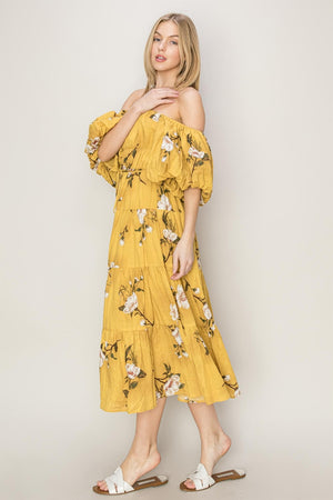 Model wearing a yellow floral puff sleeve tiered dress, showcasing a romantic and whimsical style.