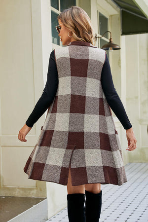 Back view of a plaid open front sleeveless cardigan with pockets, styled with a black top and knee-high boots.