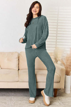 Stylish woman wearing a cozy ribbed hood top and pants set, perfect for relaxed days at home.