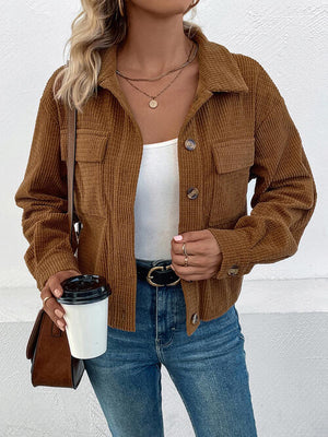 Collared neck button front jacket in brown corduroy, featuring pockets, styled with a white top and denim.