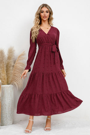 Burgundy Swiss dot tied surplice flounce sleeve dress with tiered design, perfect for casual or formal occasions.