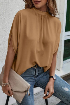 Tie Back Slit Half Sleeve Blouse in soft brown worn with jeans and a handbag, showcasing a stylish look.