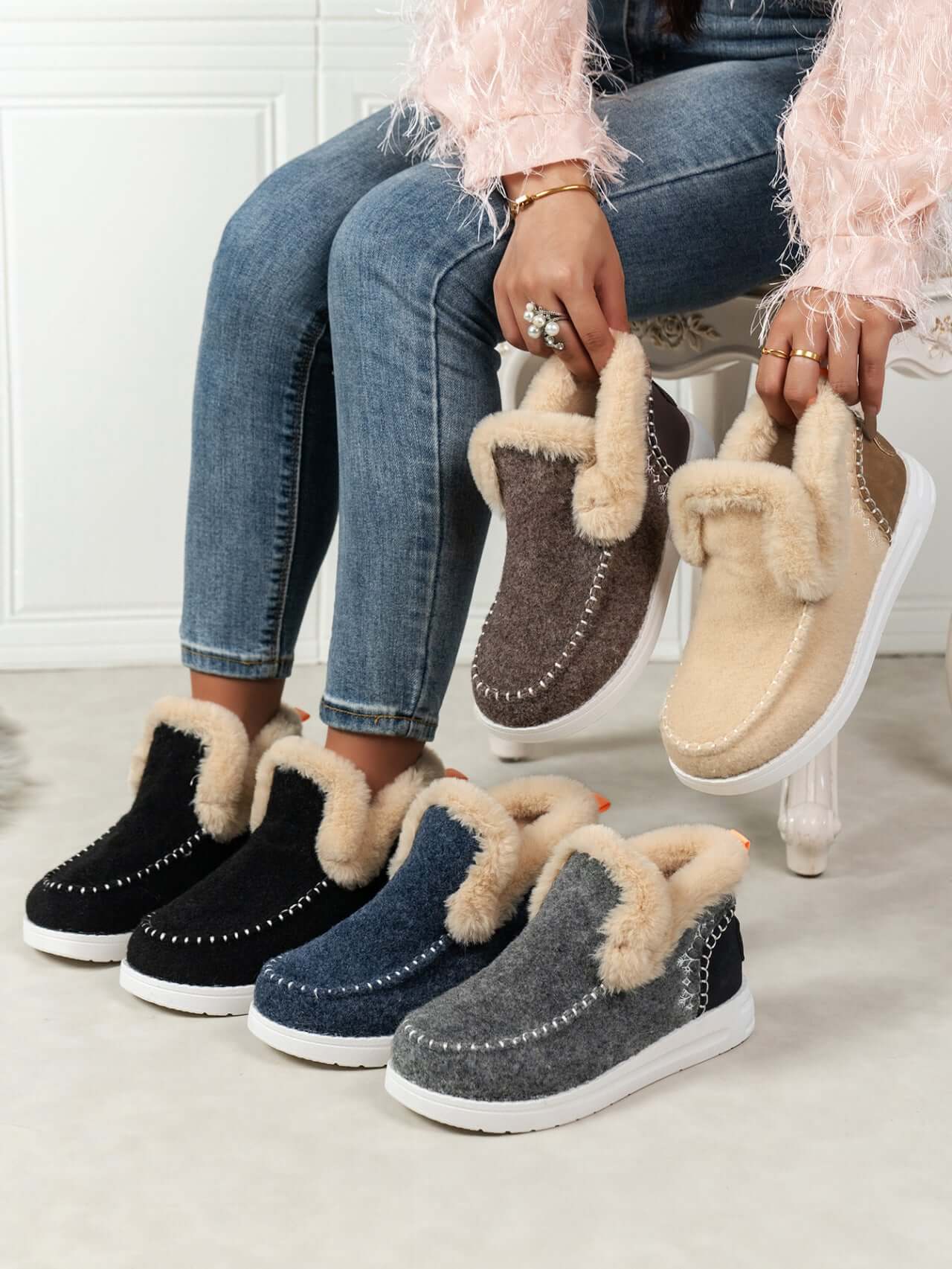 Furry suede round toe flat sneakers in various colors with fur lining, displayed by a model.