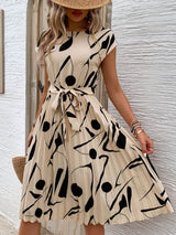 Tied pleated printed cap sleeve dress in beige with black abstract patterns, perfect for summer outings.