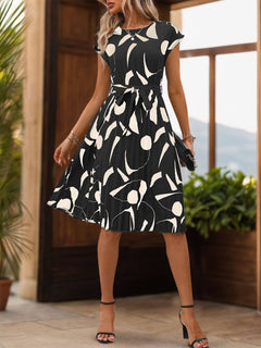 Elegant tied pleated printed cap sleeve dress with floral design, perfect for stylish summer outings.
