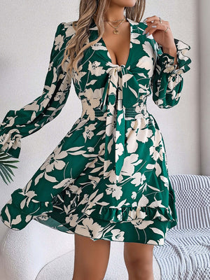 Green floral long sleeve dress featuring ruffles and tied front detail, perfect for stylish comfort.