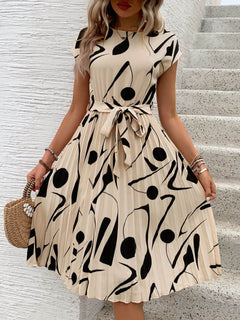 Tied pleated cap sleeve dress with abstract black and beige print, perfect for casual summer outings.