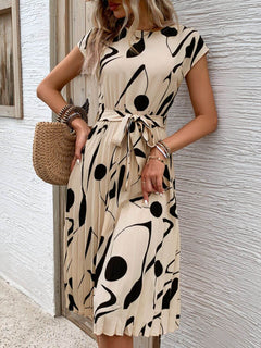 Tied pleated printed cap sleeve dress with abstract black and beige design, featuring a bow at the waist.