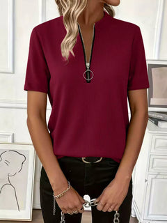 Model wearing a Half Zip Short Sleeve Top in burgundy, featuring a ribbed texture and stylish zipper detail.