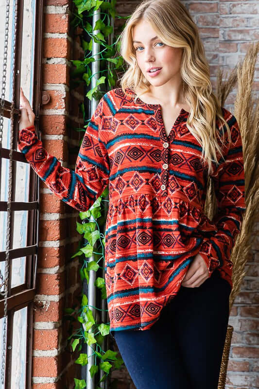 Chic long sleeve geometric babydoll top in vibrant red and orange pattern, perfect for versatile styling.