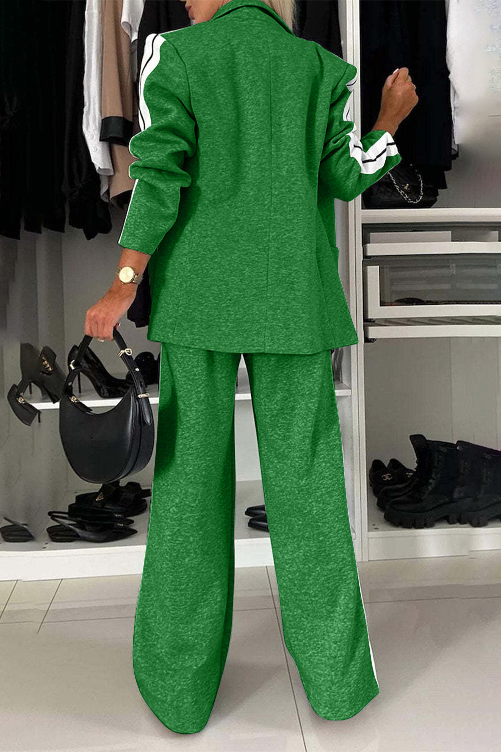 Back view of a green two-piece lapel collar top and pants set with sporty stripes.