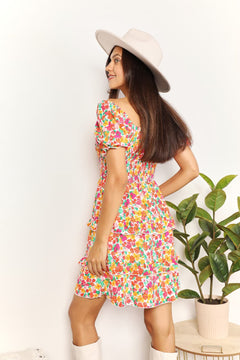 Devine Smocked Sweetheart Neck Flounce Sleeve Mini Dress shown from the back, featuring floral patterns and a playful style.