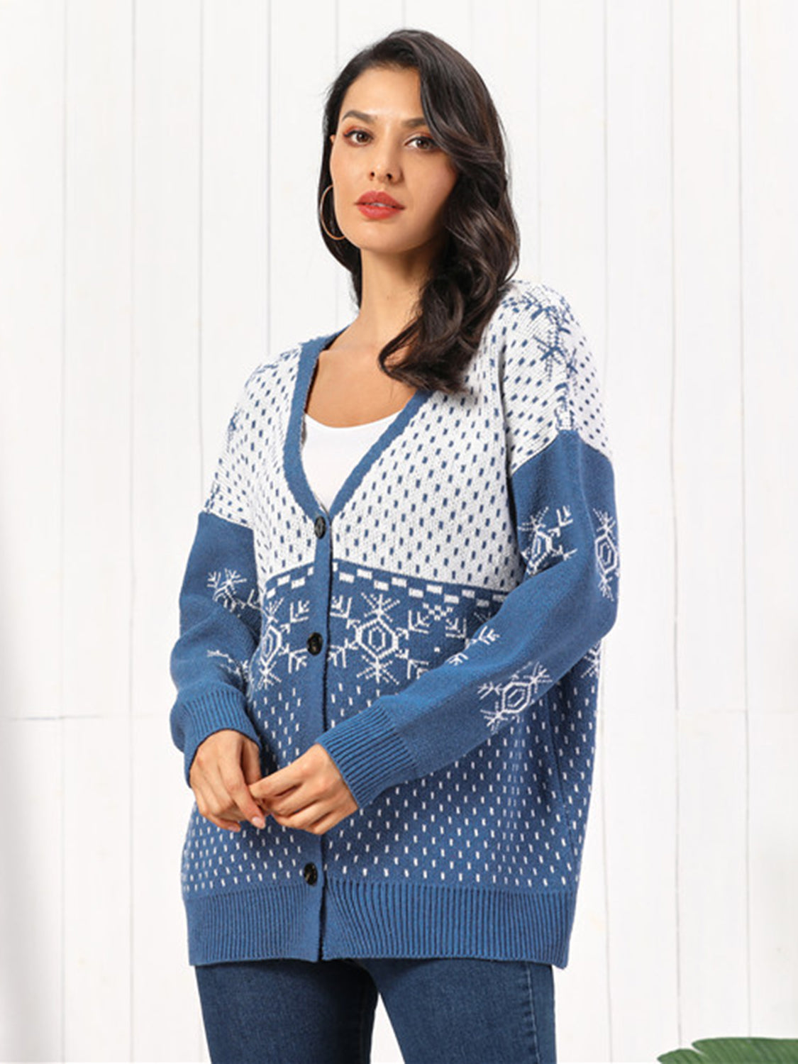 Model wearing Snowflake Button Down Cardigan in blue with snowflake pattern, perfect for winter layering.