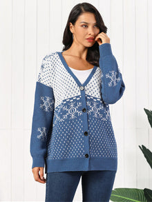 A model wearing a Snowflake Button Down Cardigan featuring a stylish blue and white snowflake design.