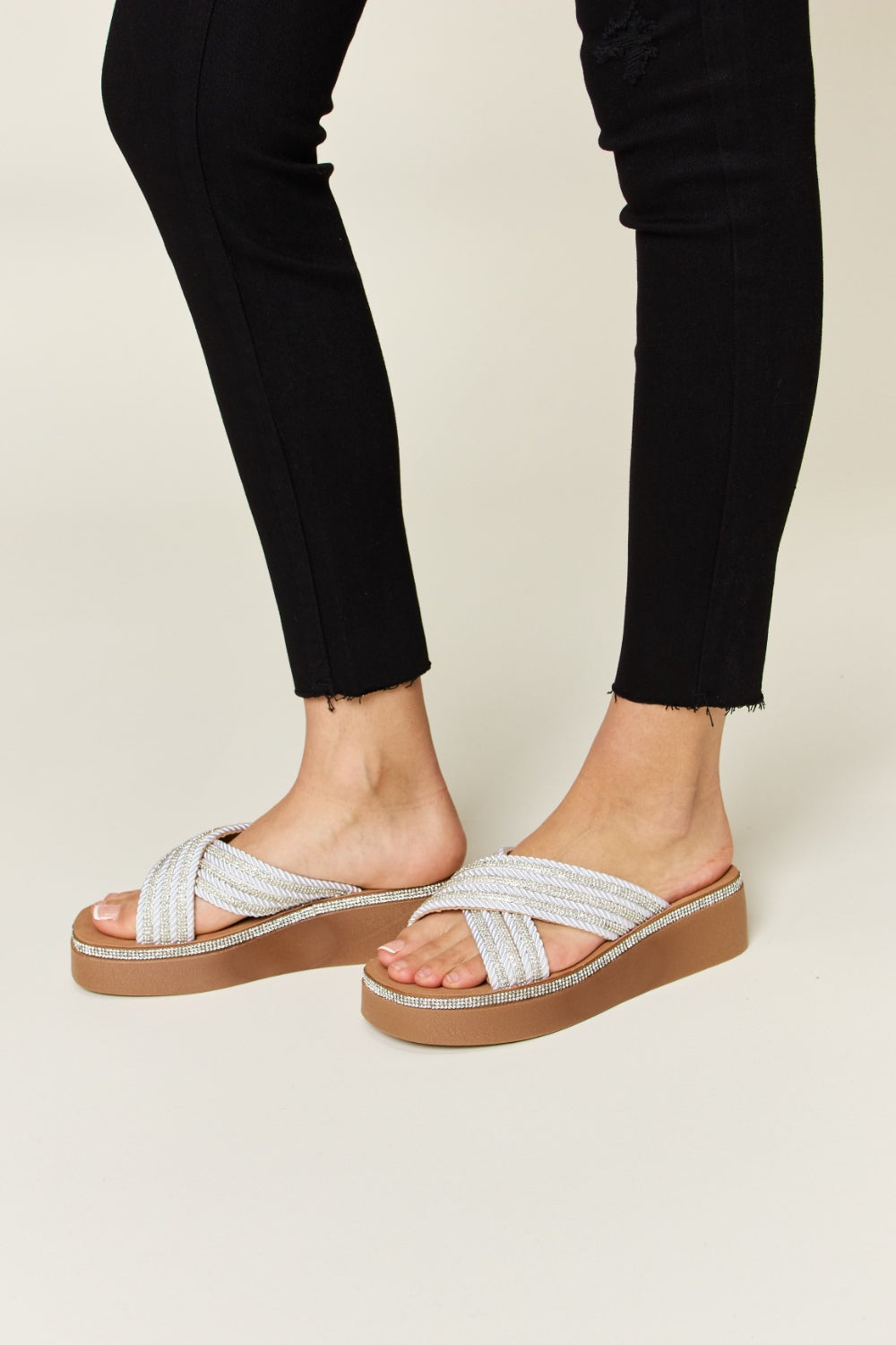 Stylish Forever Link rhinestone platform wedge sandals worn with black skinny jeans, adding glamour and comfort.