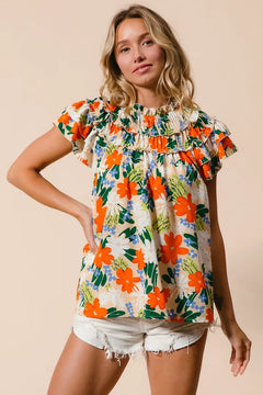 BiBi Multi Color Floral Print Woven Top with vibrant floral design and frill details paired with white shorts.