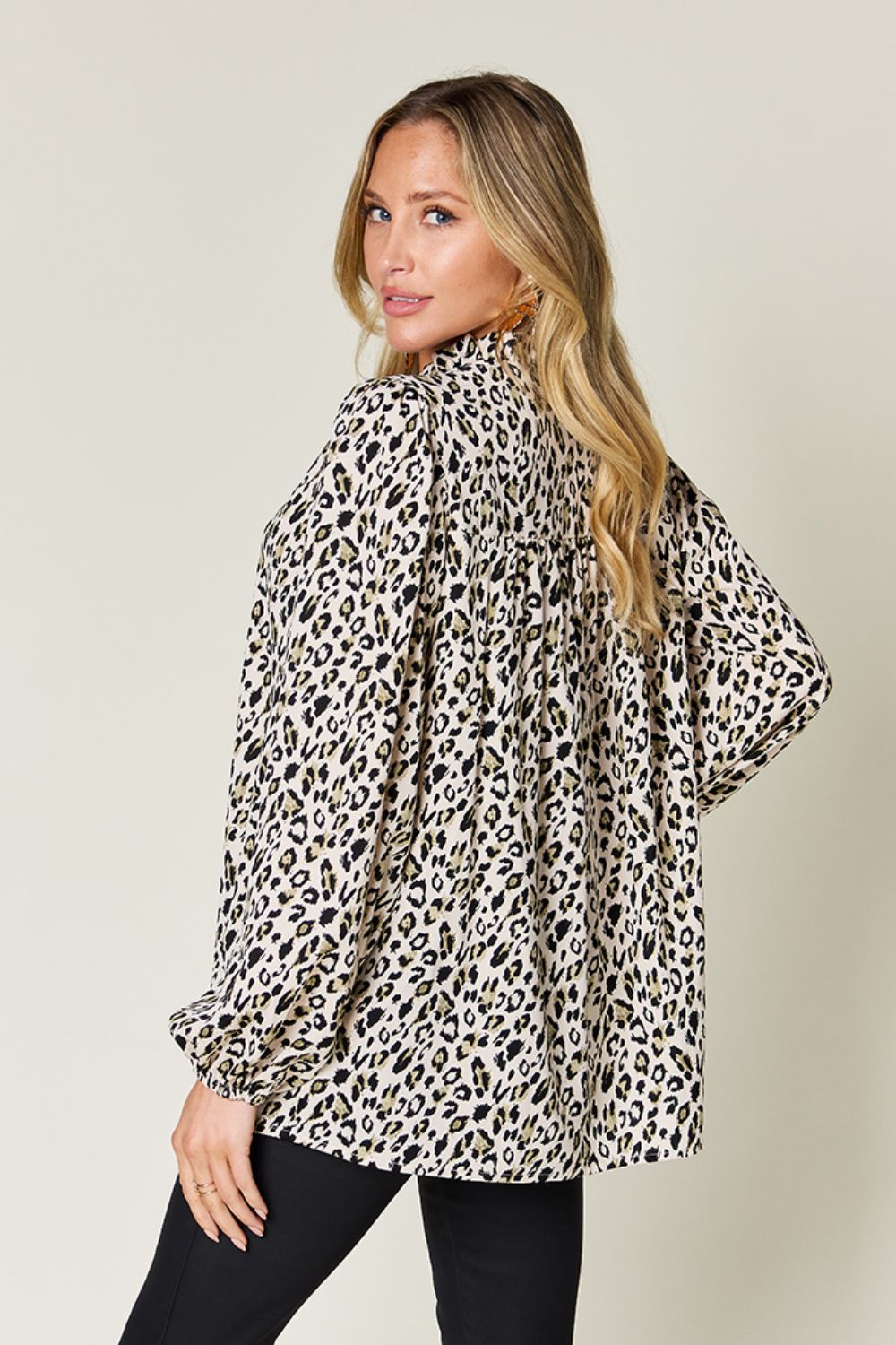 Model showcasing a double take full size leopard long sleeve blouse, featuring a stylish frill and spacious fit.