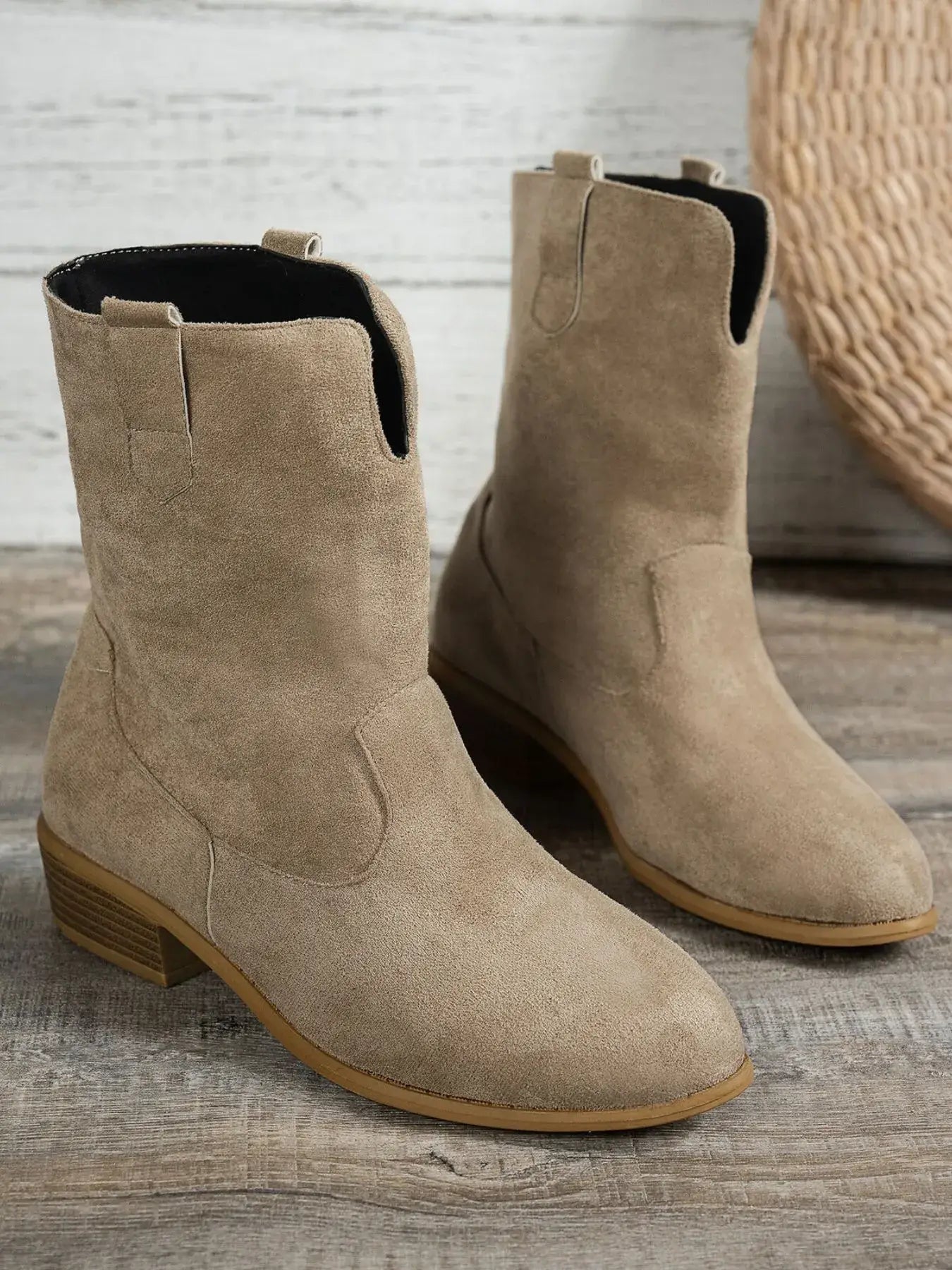 Western style block heel boots in beige suede, perfect for casual outfits. Low heel for comfortable wear.