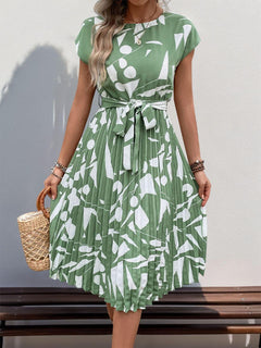 Tied pleated printed cap sleeve dress in green with white patterns, perfect for summer outings.